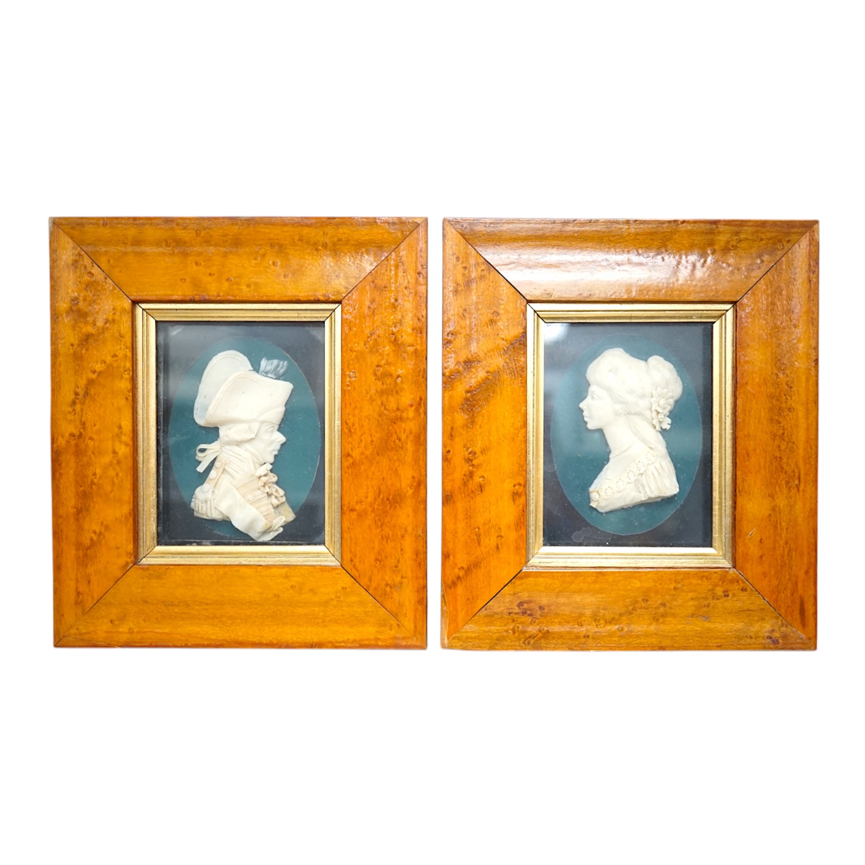 Attributed to Leslie Ray (20th century), a pair of maple framed wax reliefs, a lady and a gentleman in naval uniform, 21.5 x 19cm total. Condition - good